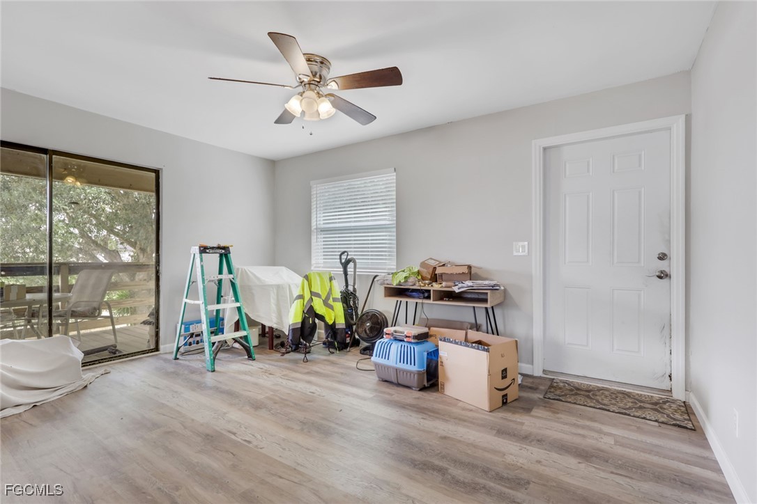 1506 Rena Avenue South Lehigh Acres, FL 33976 - Photo 4 of 39 a living room with furniture a window and gym equipment