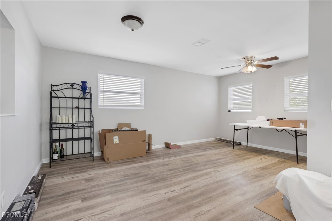 1506 Rena Avenue South Lehigh Acres, FL 33976 - Photo 8 of 39 a living room with furniture and a wooden floor