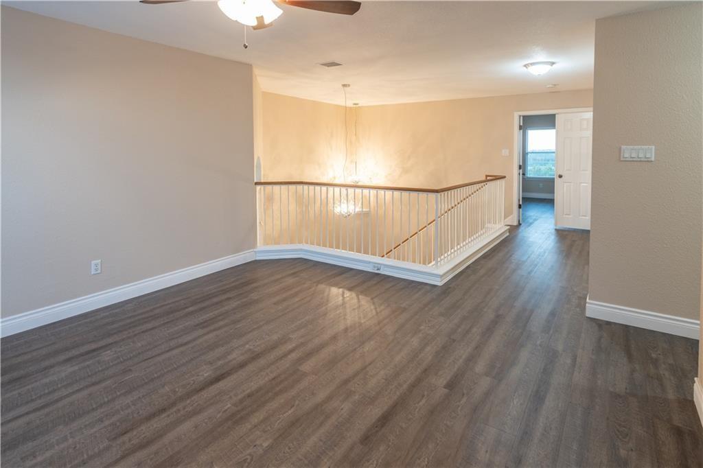 12017 Springs Head Loop Austin, TX 78717 - Photo 13 of 25 A versatile open landing with rich flooring, perfect for a cozy reading nook or a home office.