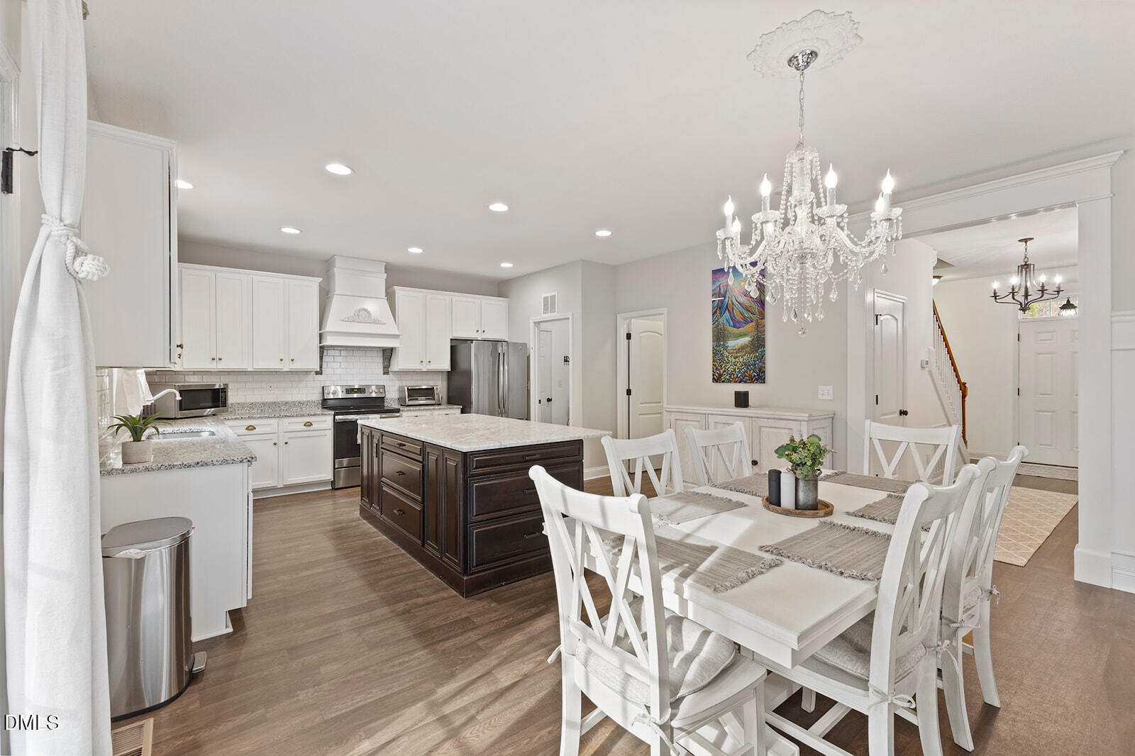1021 Coley Road Raleigh, NC 27613 - Photo 10 of 42 a kitchen with stainless steel appliances kitchen island granite countertop a table chairs and a refrigerator