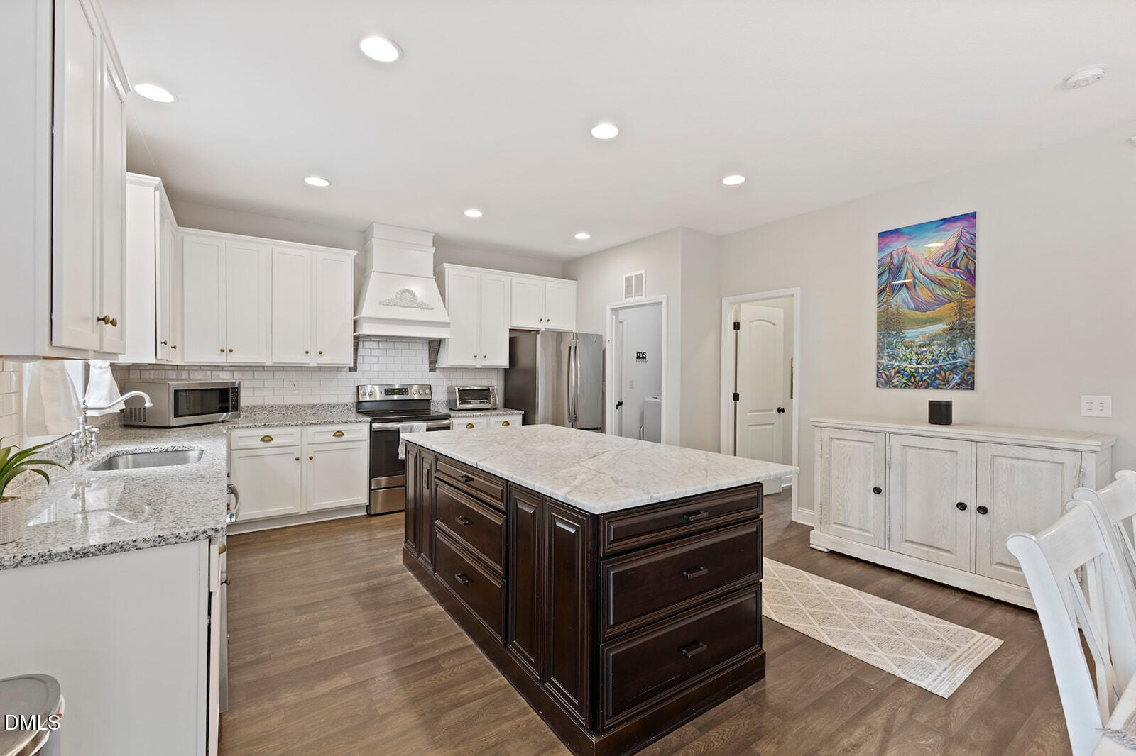 1021 Coley Road Raleigh, NC 27613 - Photo 11 of 42 a kitchen with white cabinets and appliances