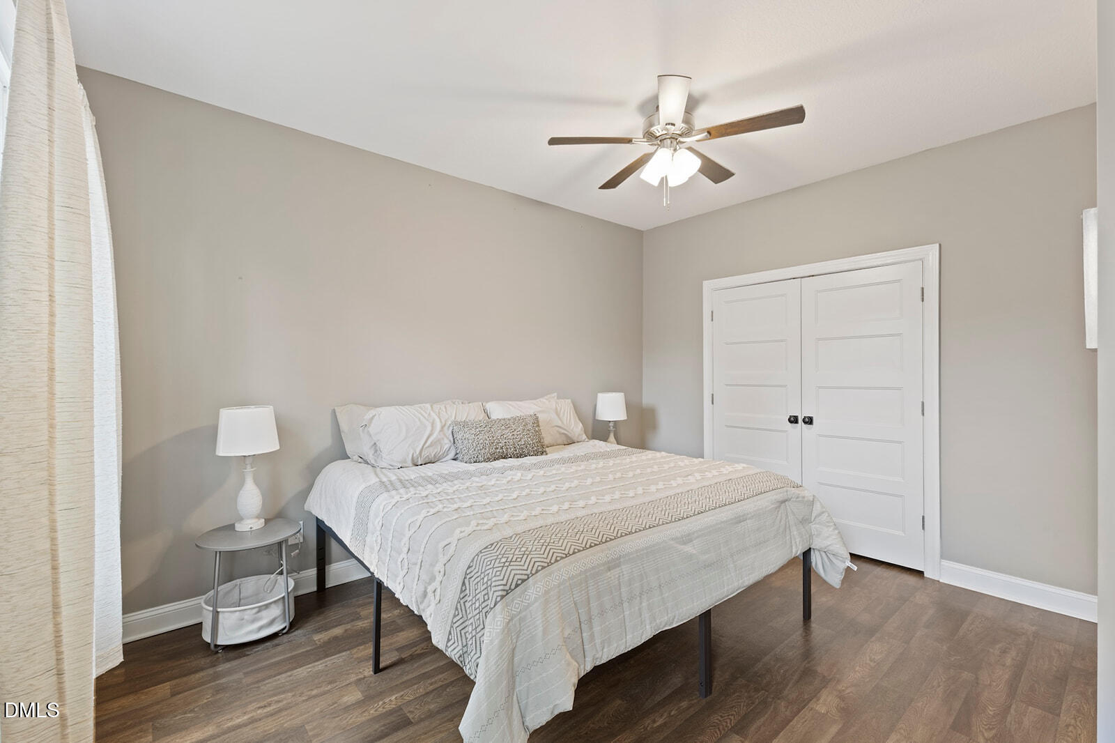 1021 Coley Road Raleigh, NC 27613 - Photo 16 of 42 a bedroom with a bed and a ceiling fan