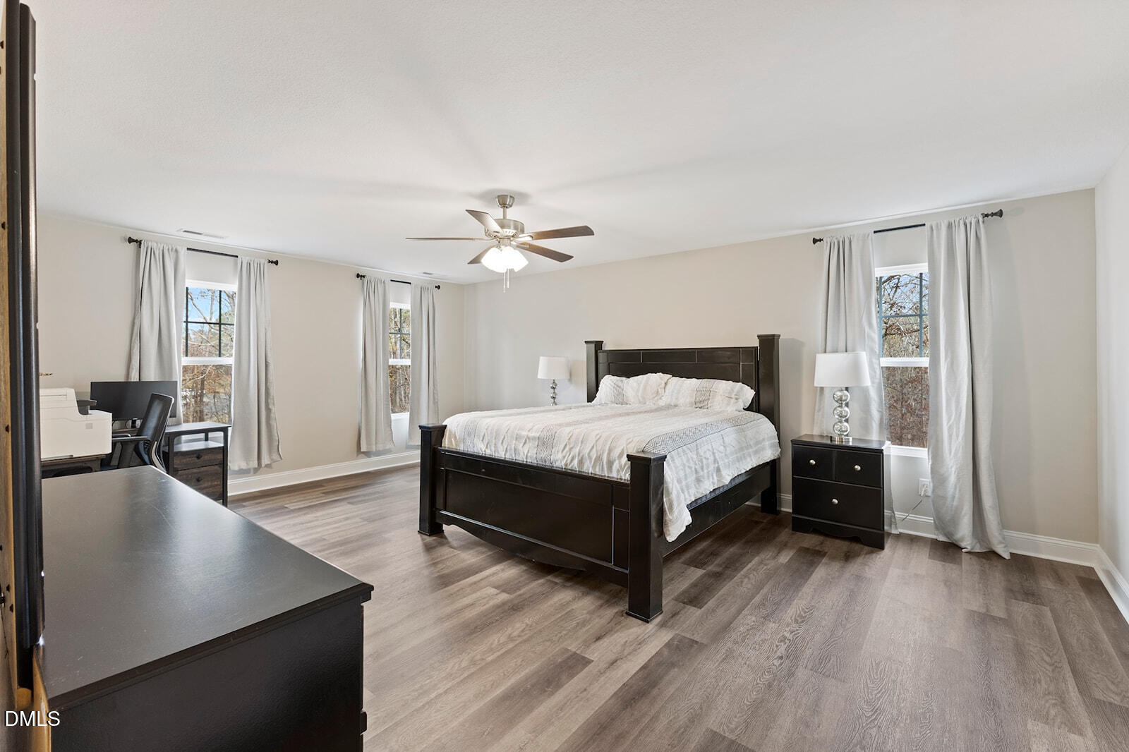 1021 Coley Road Raleigh, NC 27613 - Photo 19 of 42 a bedroom with a bed and wooden floor