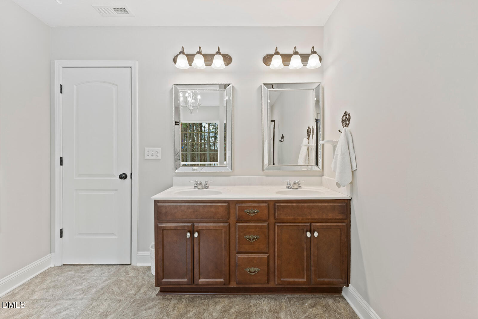 1021 Coley Road Raleigh, NC 27613 - Photo 22 of 42 a bathroom with a granite countertop sink and a mirror