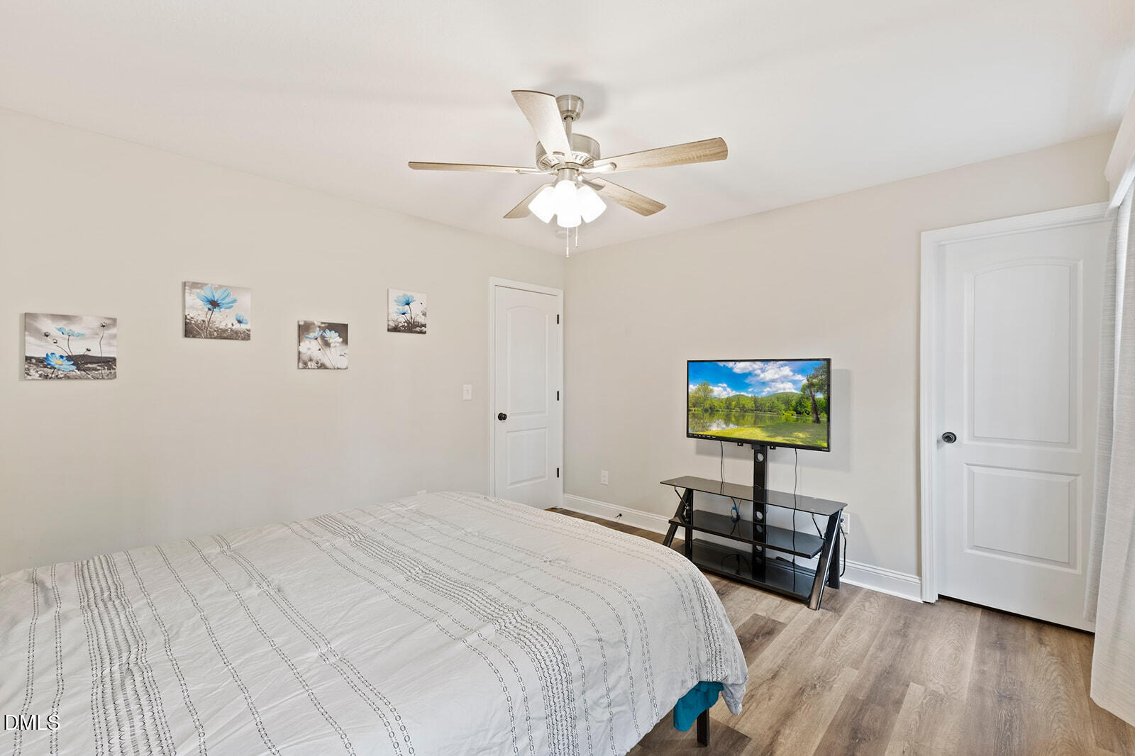 1021 Coley Road Raleigh, NC 27613 - Photo 24 of 42 a bedroom with bed tv and a wall painting