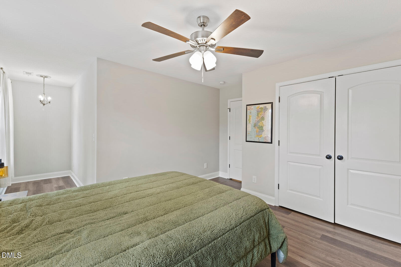 1021 Coley Road Raleigh, NC 27613 - Photo 26 of 42 a bedroom with a bed and a chandelier