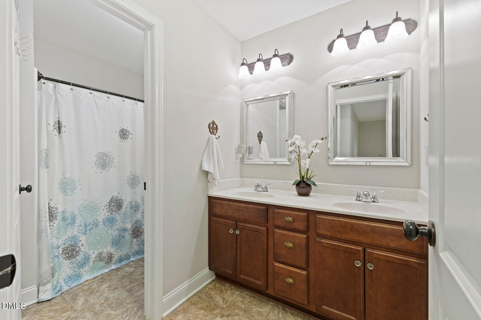 1021 Coley Road Raleigh, NC 27613 - Photo 27 of 42 a bathroom with a double vanity sink mirror and shower