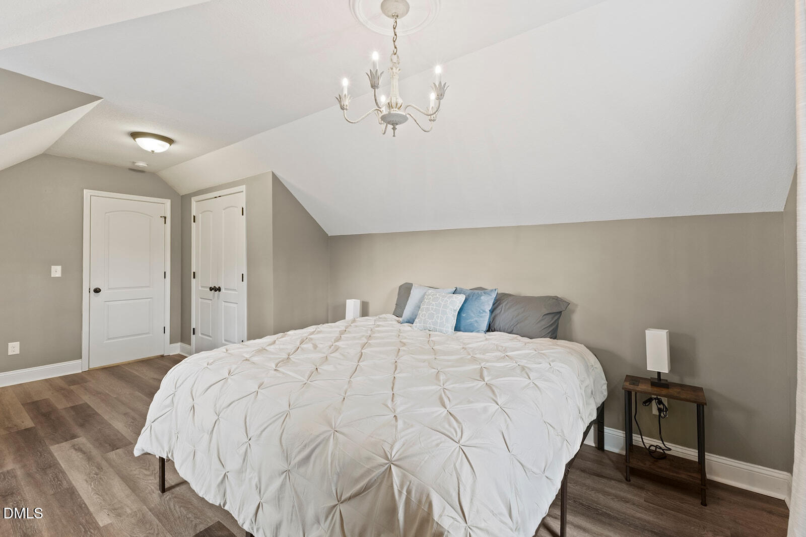 1021 Coley Road Raleigh, NC 27613 - Photo 29 of 42 a large bed sitting in a bedroom and chandelier