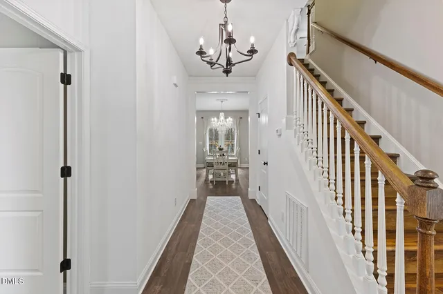 a kitchen with stainless steel appliances kitchen island granite countertop a table chairs and a refrigerator