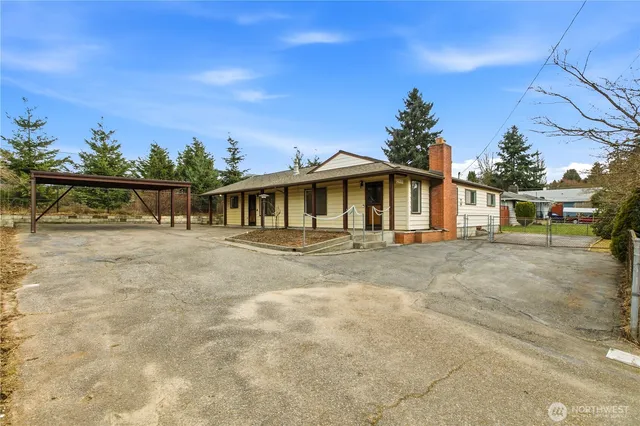 a view of a white house with a swimming pool