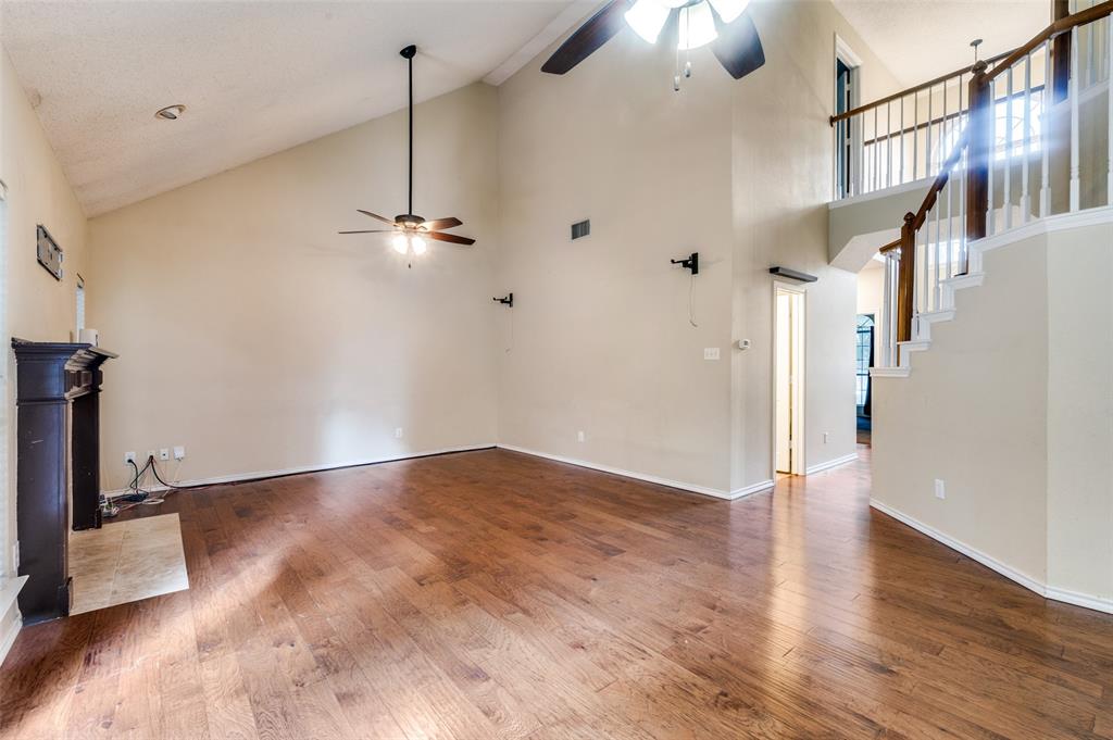 3902 Amy Court Arlington, TX 76016 - Photo 5 of 26 Living room, with the half bath at the bottom of the stairs, and the front door beyond