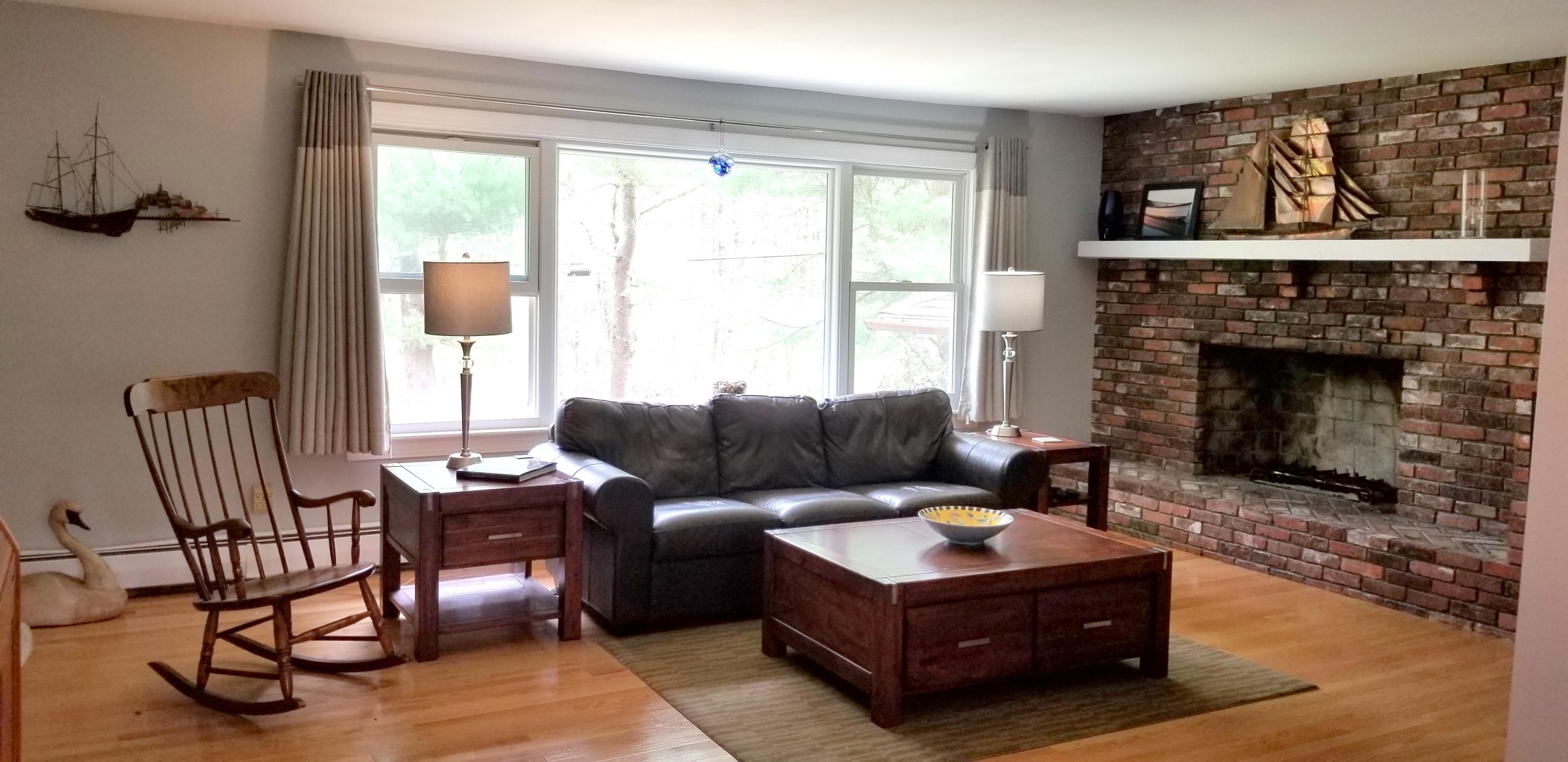 628 County Road Pocasset, MA 02559 - Photo 2 of 21 a living room with furniture and a fireplace