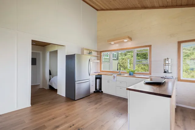 a kitchen with a refrigerator and a stove top oven