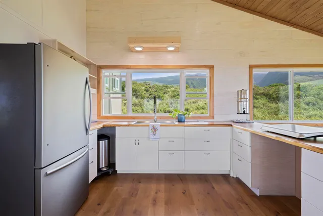 a kitchen with sink cabinets and wooden floor
