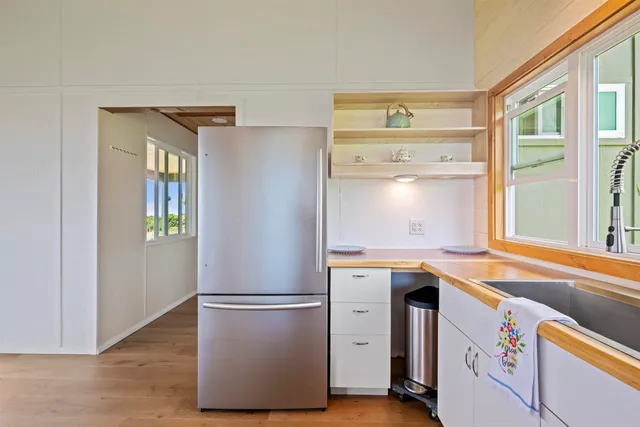 a utility room with closet dryer and windows
