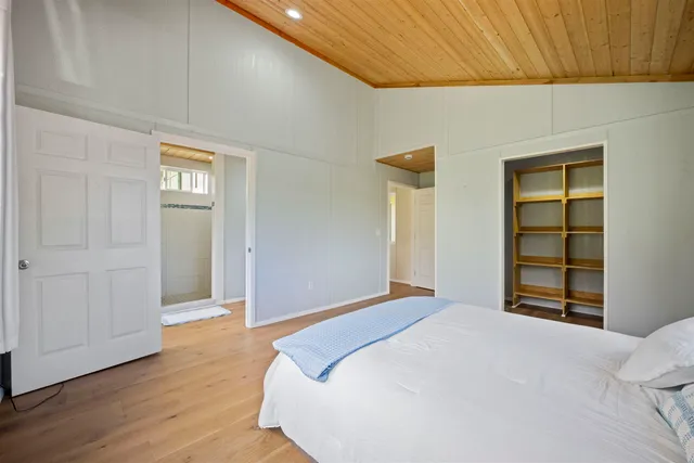 a bedroom with a bed and a closet