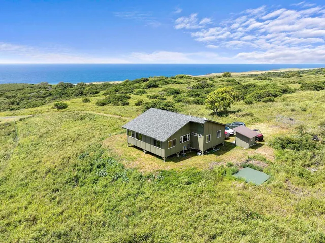 a view of a yard with an ocean view