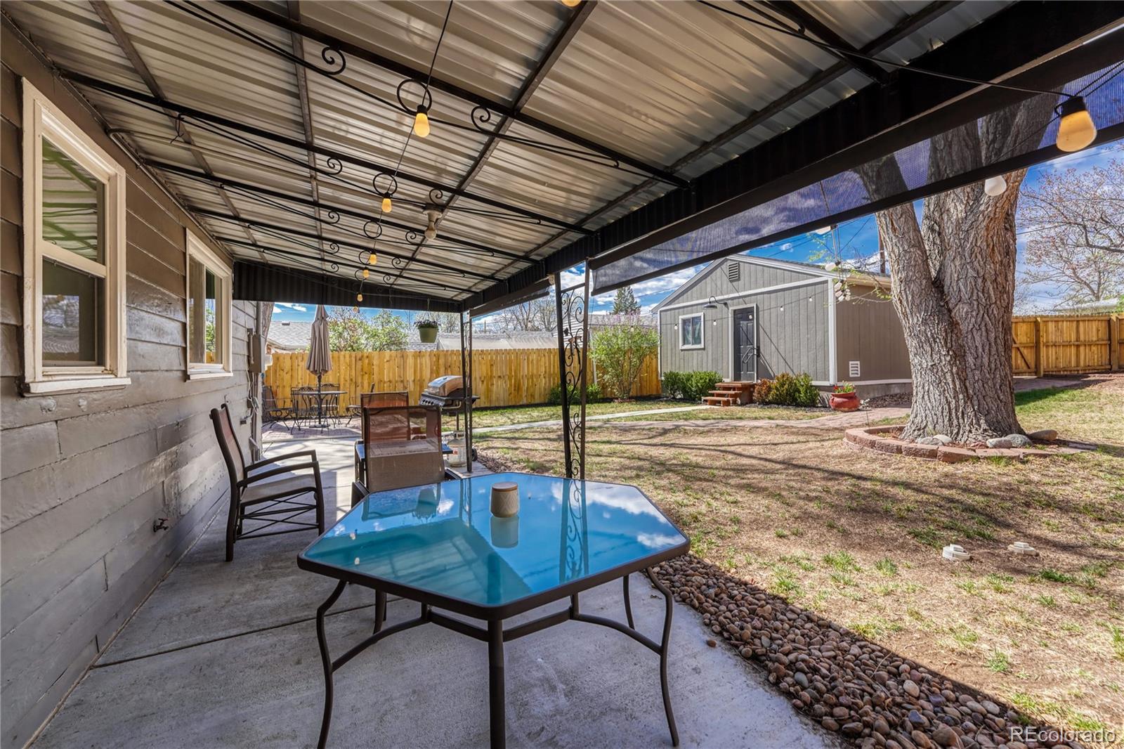 1111 South Perry Street Denver, CO 80219 - Photo 11 of 23 a view of a patio with a table and chairs