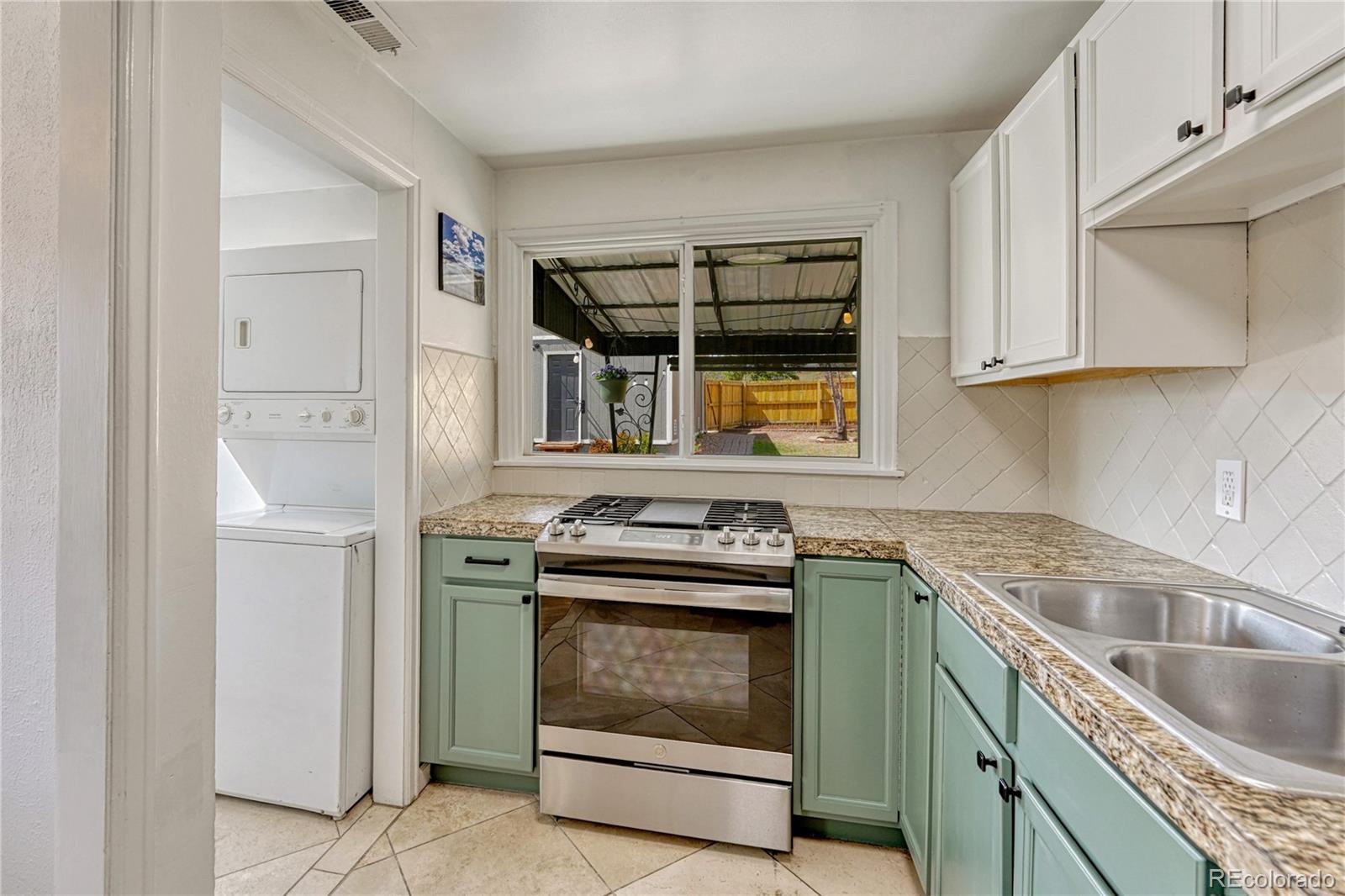 1111 South Perry Street Denver, CO 80219 - Photo 16 of 23 a kitchen with a stove microwave and cabinets