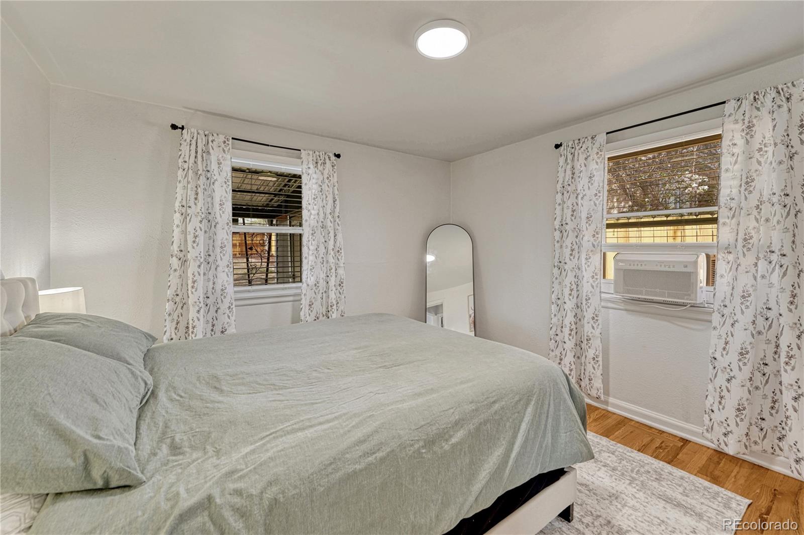 1111 South Perry Street Denver, CO 80219 - Photo 17 of 23 a bedroom with a bed and a window