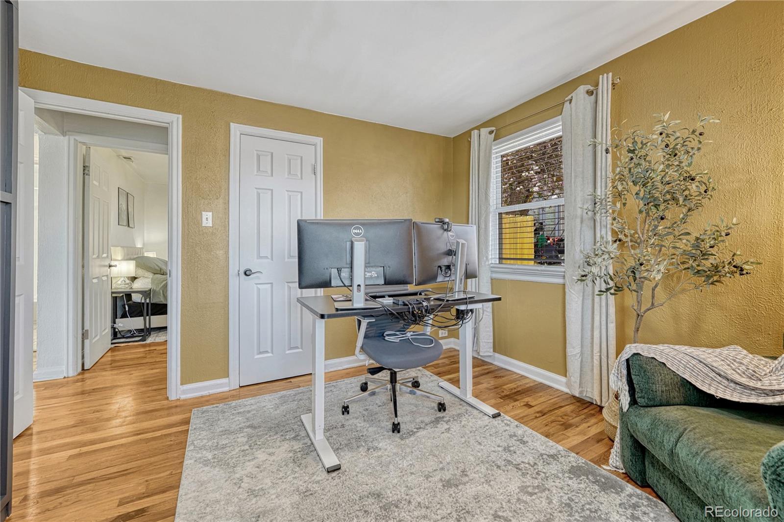 1111 South Perry Street Denver, CO 80219 - Photo 18 of 23 a workspace with furniture and a gate