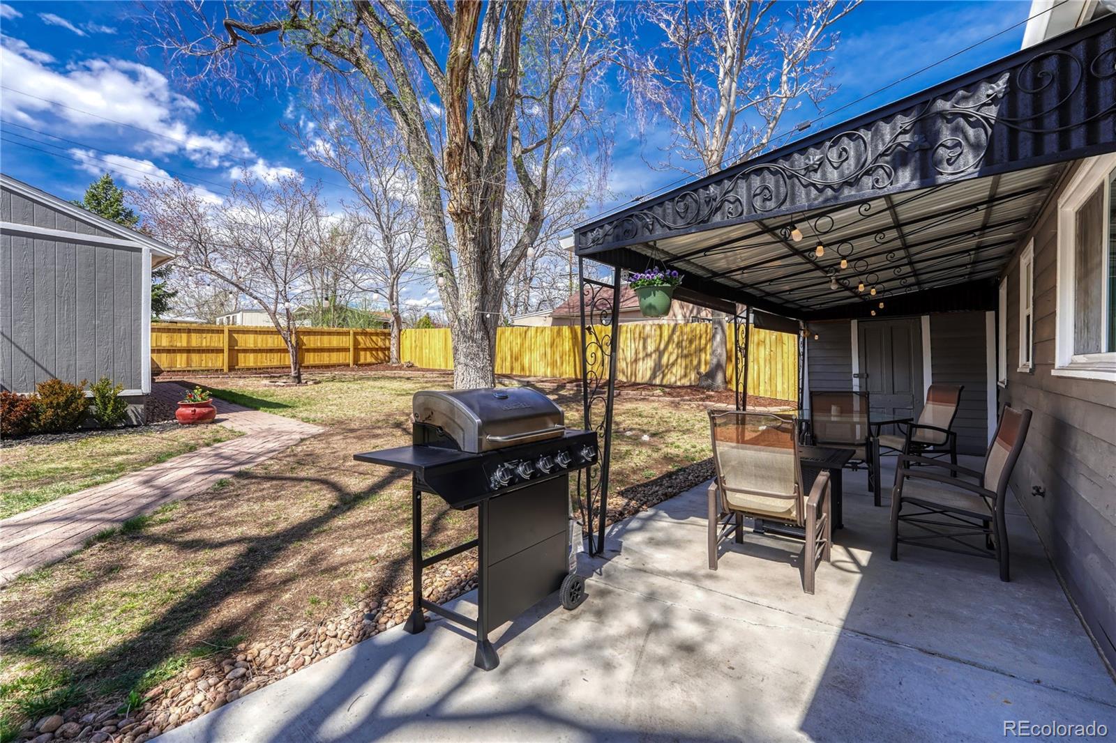 1111 South Perry Street Denver, CO 80219 - Photo 19 of 23 a view of a swimming pool with chairs and tables