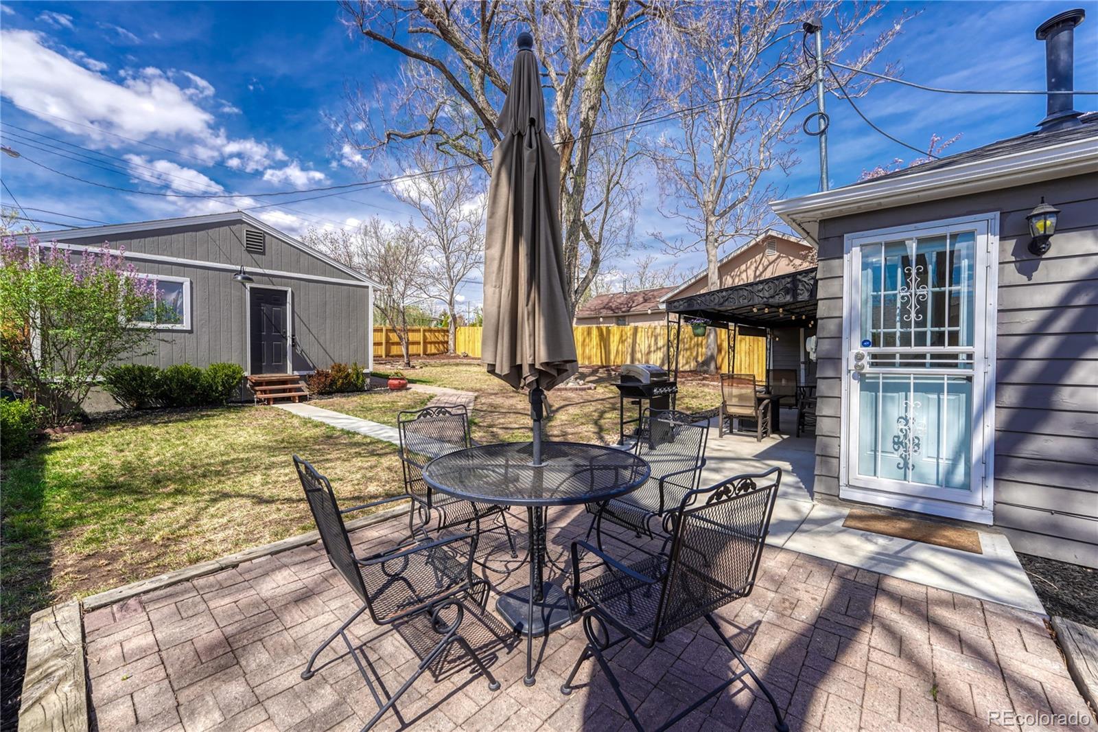 1111 South Perry Street Denver, CO 80219 - Photo 20 of 23 a view of a patio with table and chairs and potted plants