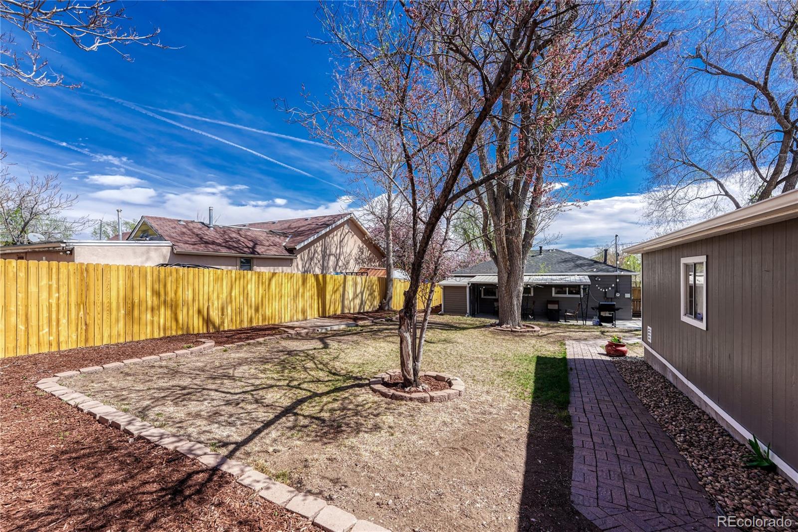 1111 South Perry Street Denver, CO 80219 - Photo 21 of 23 a view of a backyard with a house