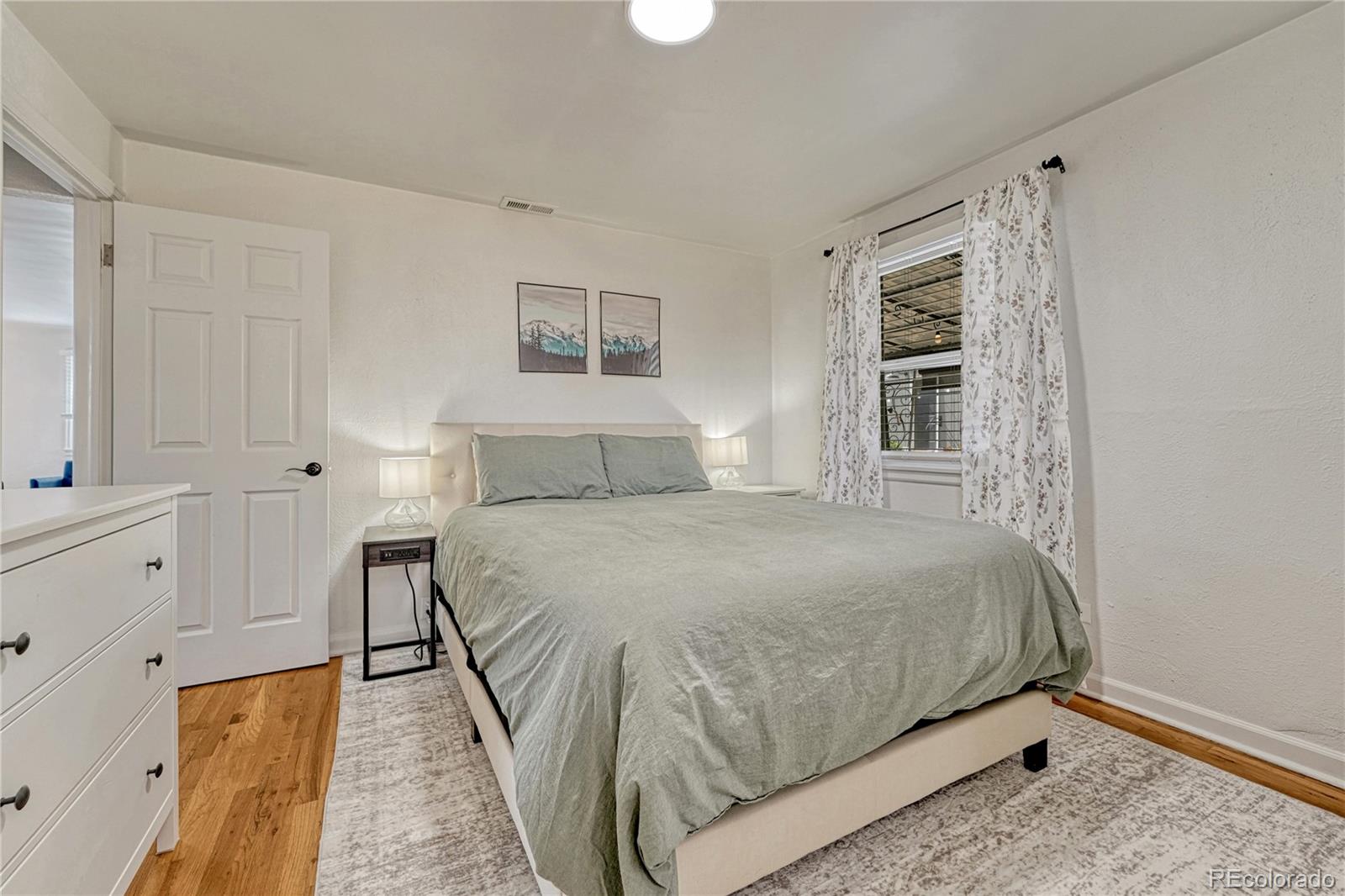 1111 South Perry Street Denver, CO 80219 - Photo 6 of 23 a bedroom with a bed and a window