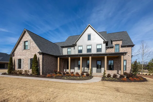 a front view of a house with yard outdoor seating and garage