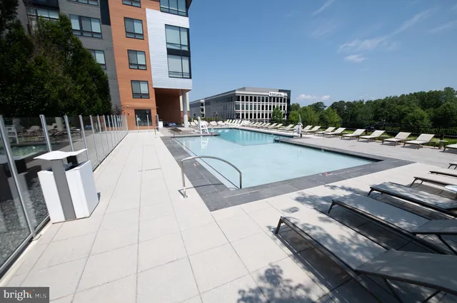 a view of a patio with swimming pool and sitting area