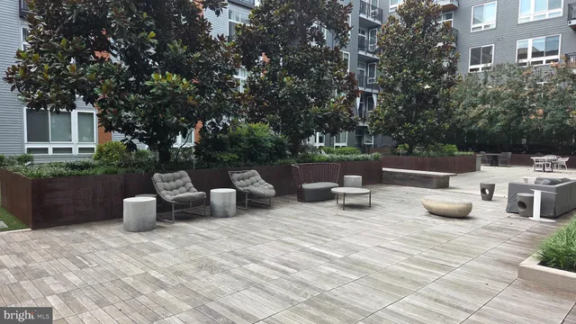 a view of a patio with chairs and plants