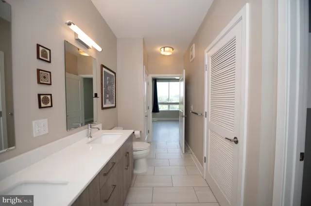 a bathroom with a double vanity sink and mirror