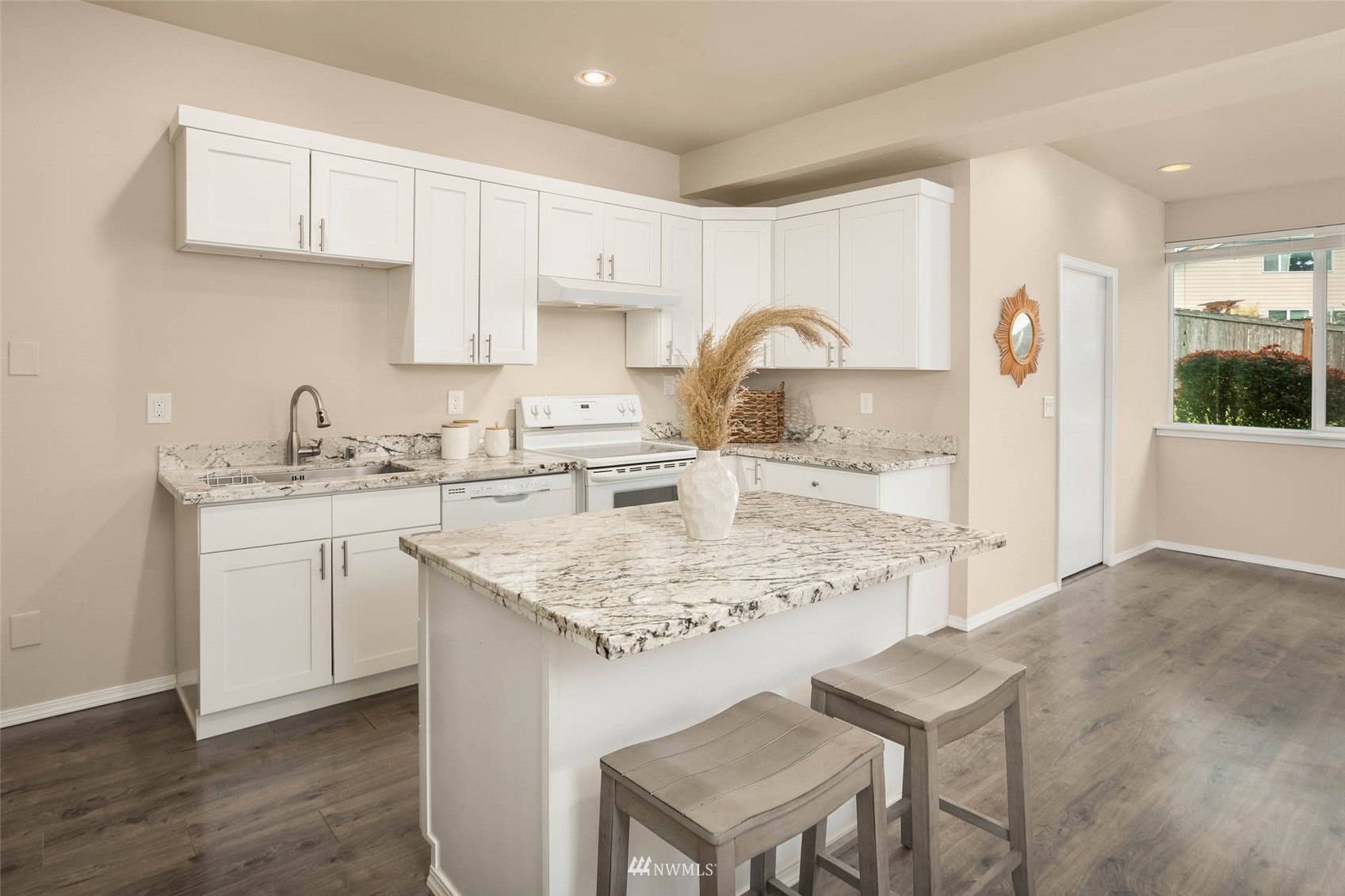 314 171st Street Southeast Bothell, WA 98012 - Photo 27 of 36 a kitchen with kitchen island a sink stove and white cabinets