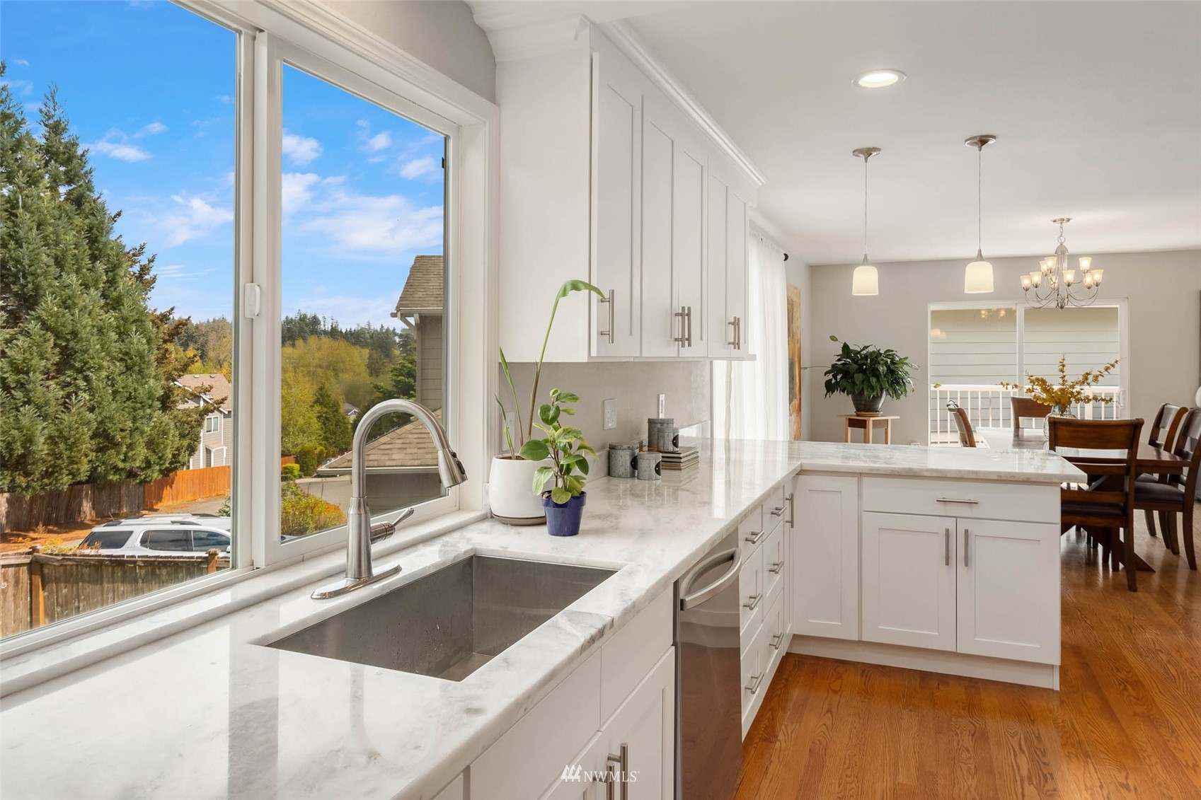 314 171st Street Southeast Bothell, WA 98012 - Photo 10 of 36 a kitchen with white cabinets a sink and a large window