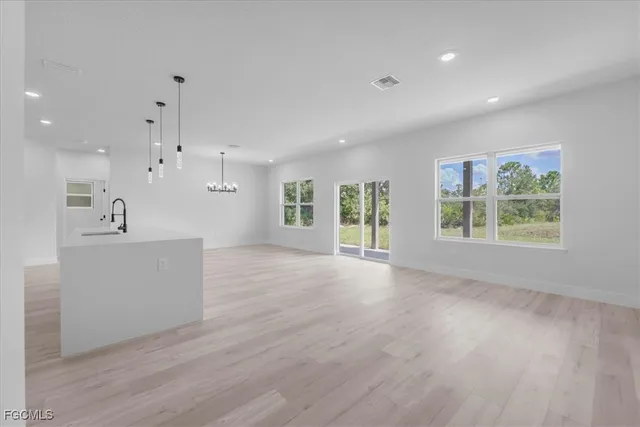 a view of a kitchen with furniture and wooden floor