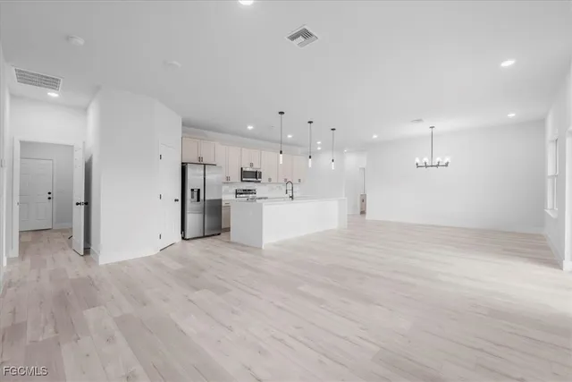 a view of a kitchen with a sink and a refrigerator