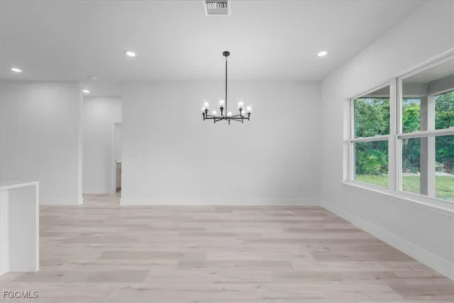 a view of a room with a ceiling fan window and a ceiling fan