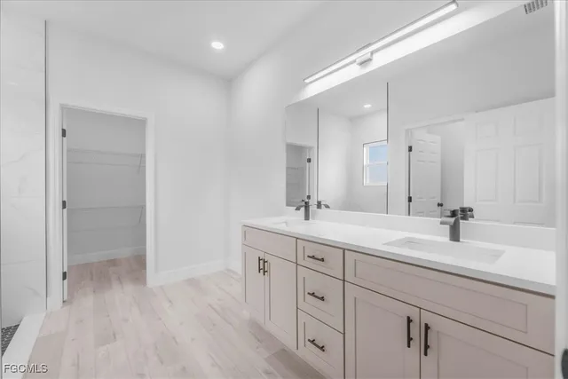 a bathroom with a double vanity sink and mirror
