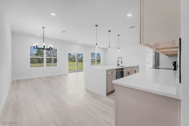 a kitchen with stainless steel appliances kitchen island wooden cabinets and a stove