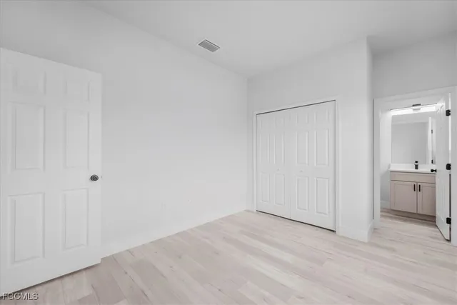 a view of a room with wooden floor and a sink