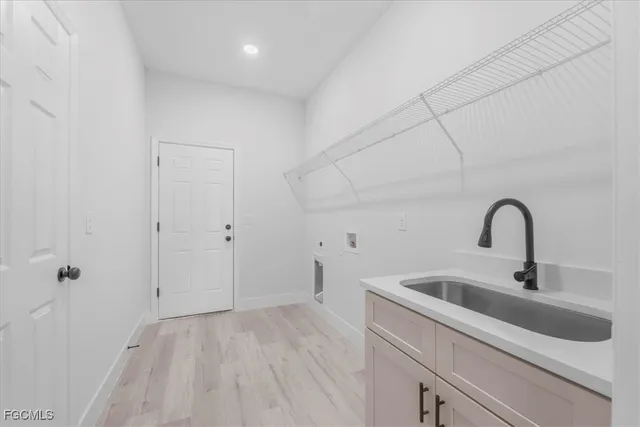 a view of a kitchen with sink and refrigerator