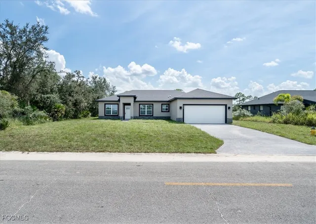 a street sign on a wall next to a road
