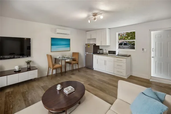 a living room with furniture and a flat screen tv