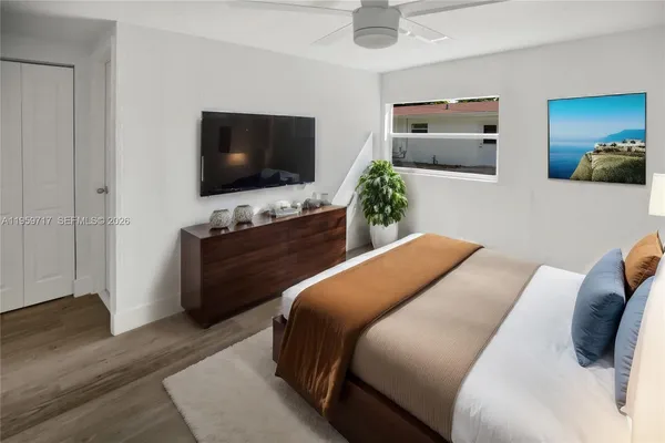 a bedroom with a bed and a flat screen tv
