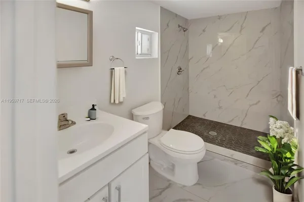 a bathroom with a sink toilet and shower