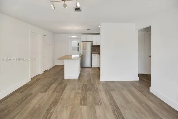 a view of a kitchen with wooden floor