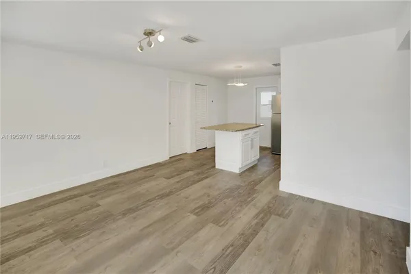 a view of a room with wooden floor and sink