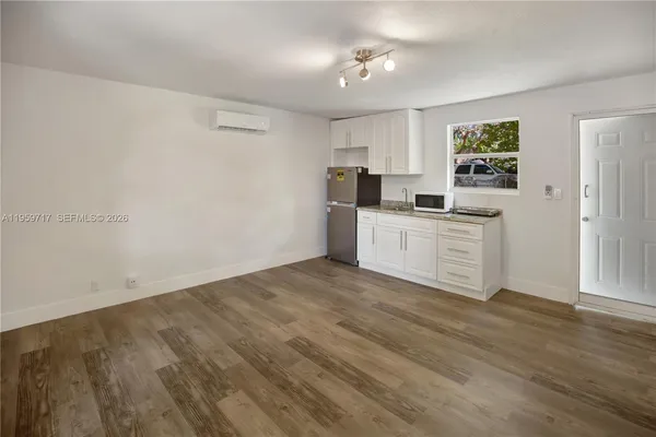 a kitchen with a sink cabinets and wooden floor