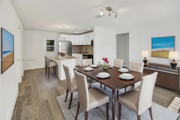 a view of a dining room with furniture and wooden floor